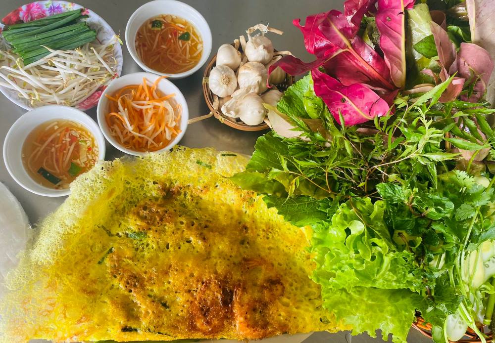 Bánh xèo A Đạt gây ấn tượng với thực khách nhờ phần rau rừng ăn kèm siêu đa dạng (Ảnh: Bánh xèo rau rừng A Đạt)